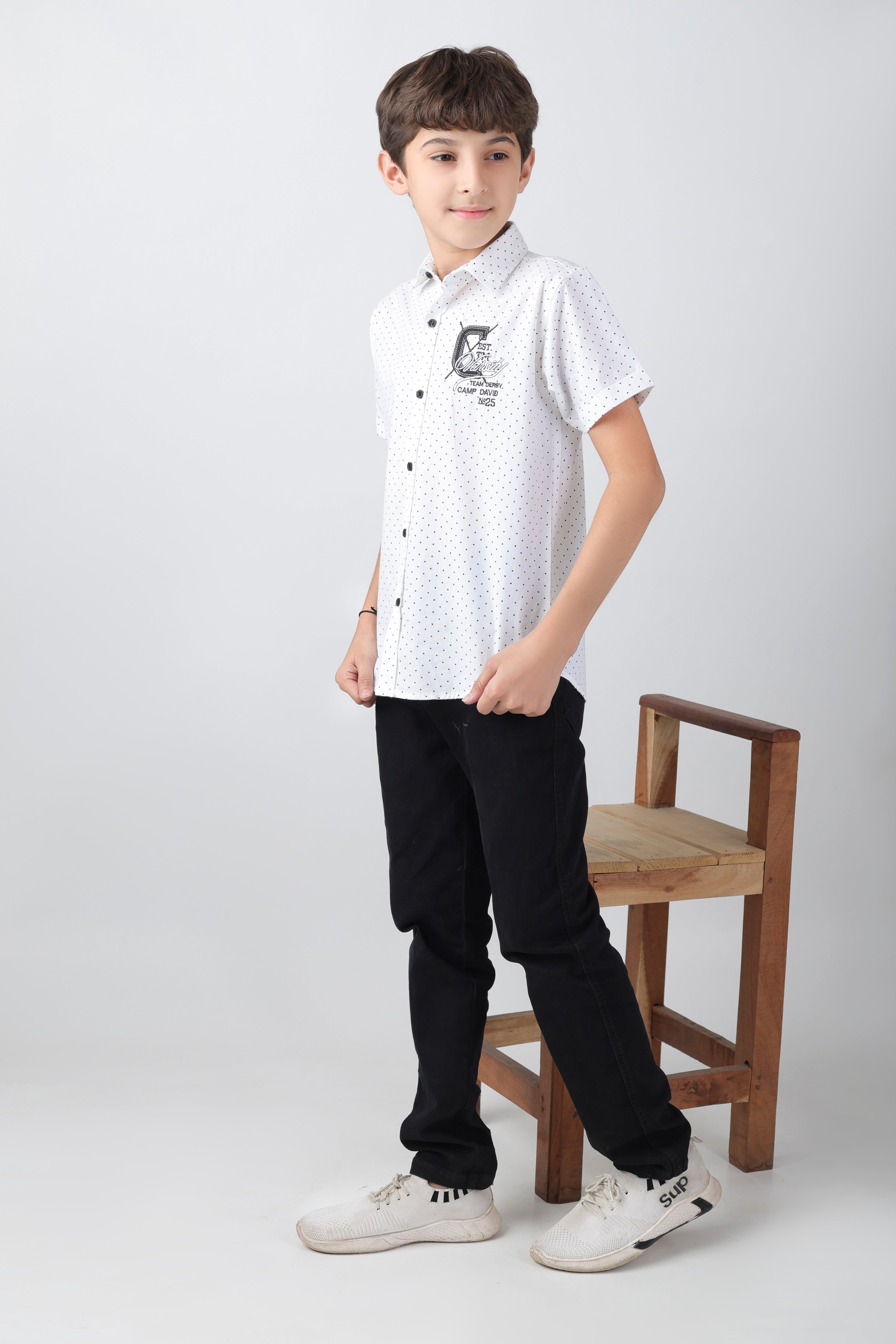 Crisp white short sleeve shirt with a polka-dot base and an embroidery patch