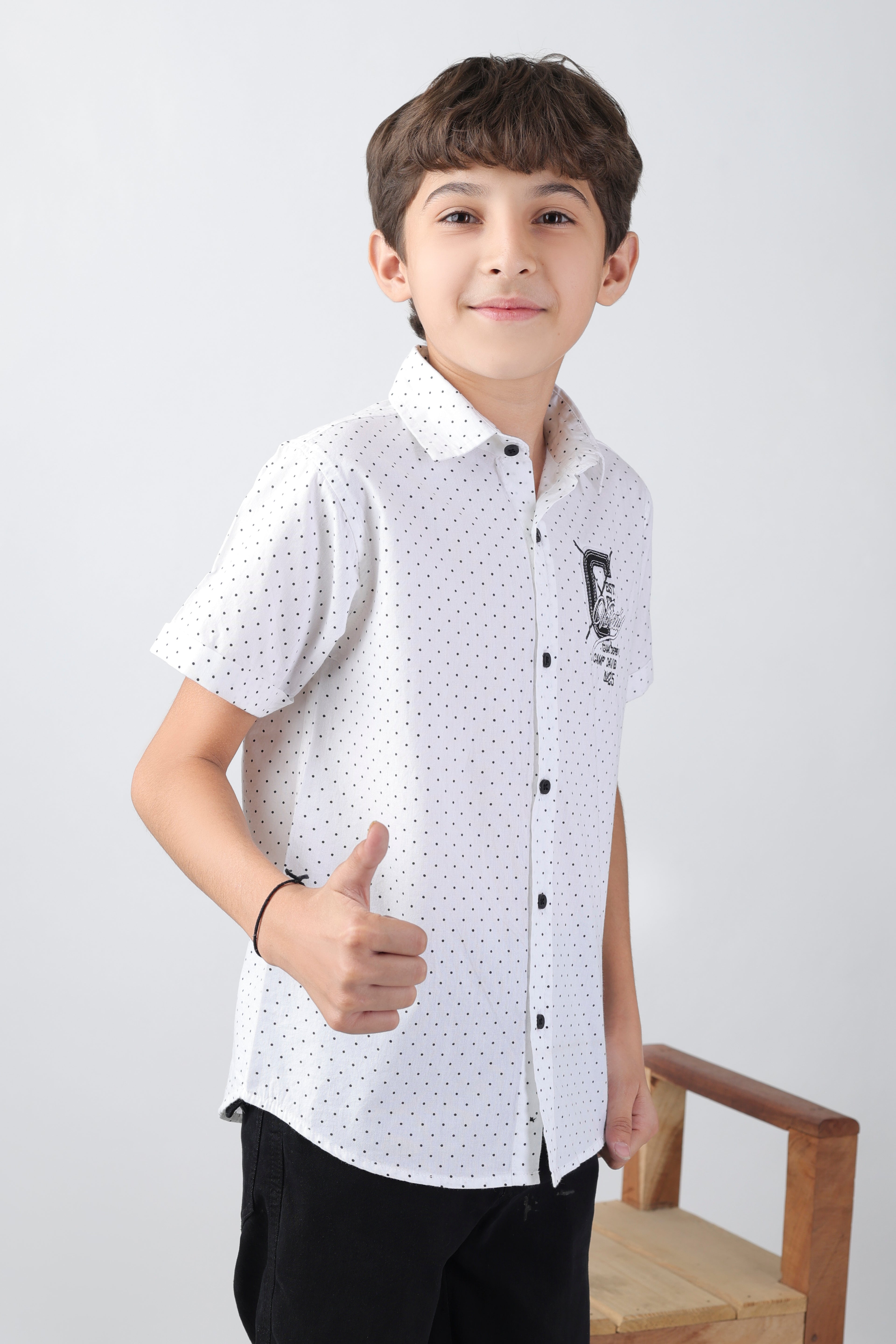 Crisp white short sleeve shirt with a polka-dot base and an embroidery patch