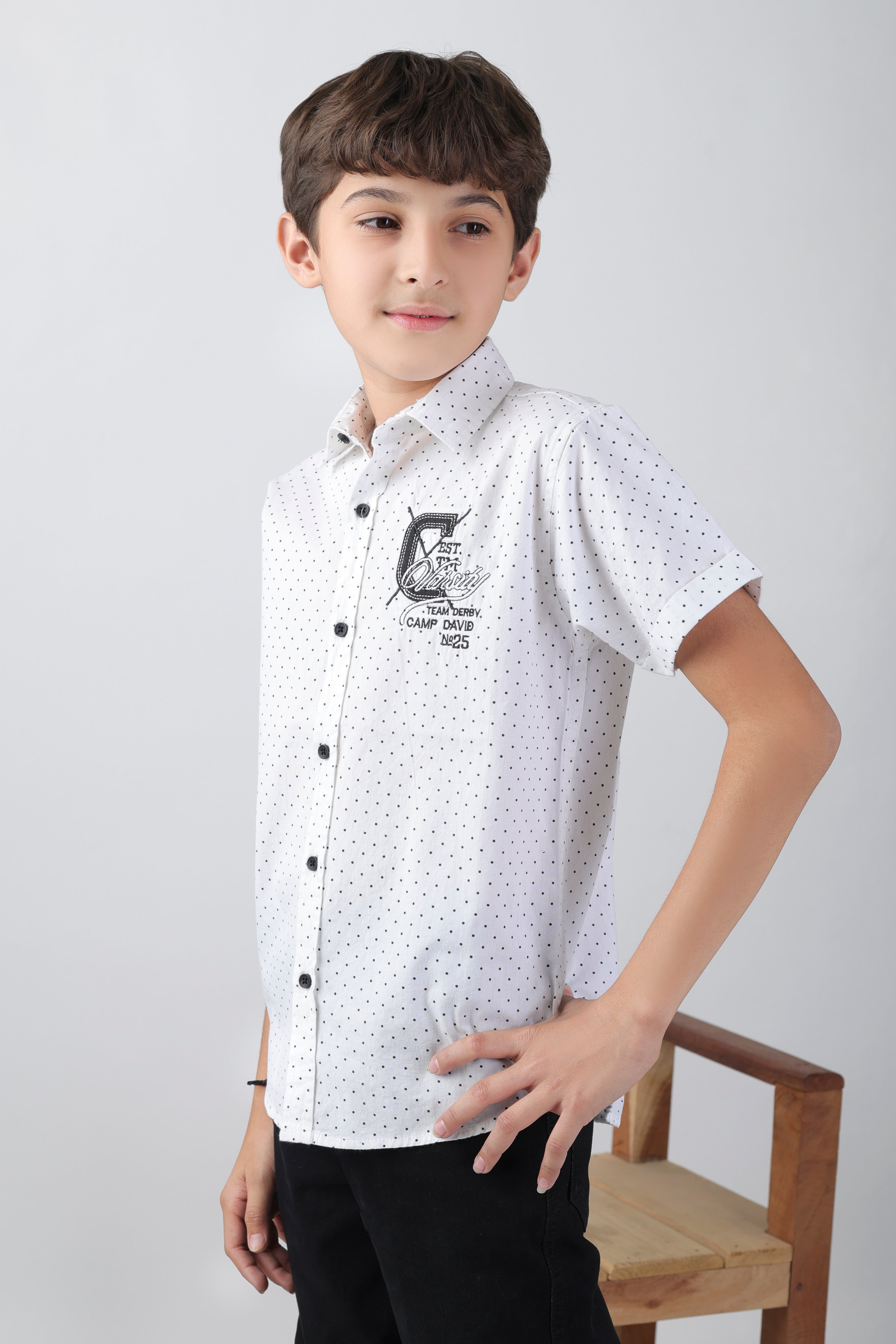 Crisp white short sleeve shirt with a polka-dot base and an embroidery patch