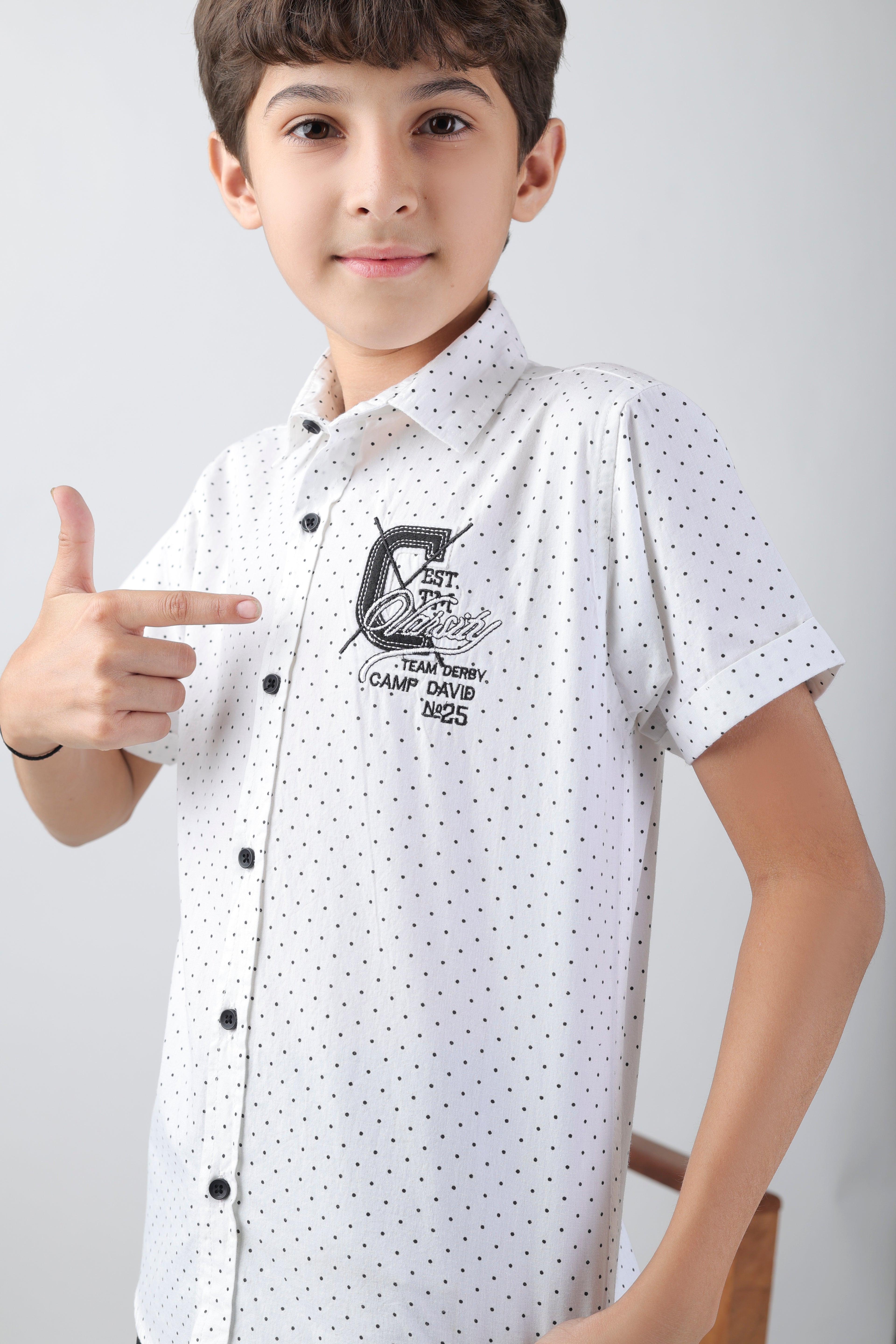 Crisp white short sleeve shirt with a polka-dot base and an embroidery patch