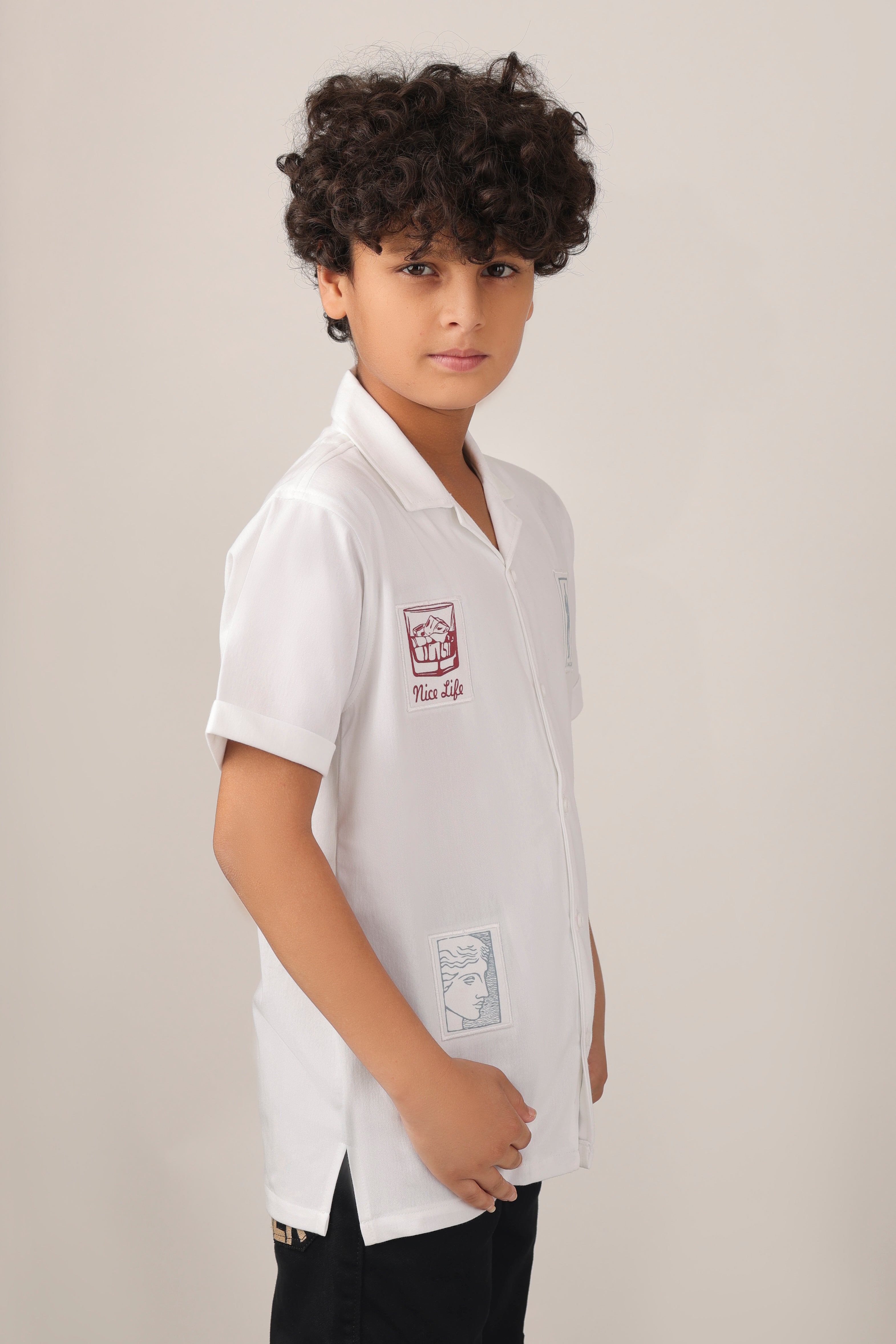 Crisp white short-sleeve design with camp collar