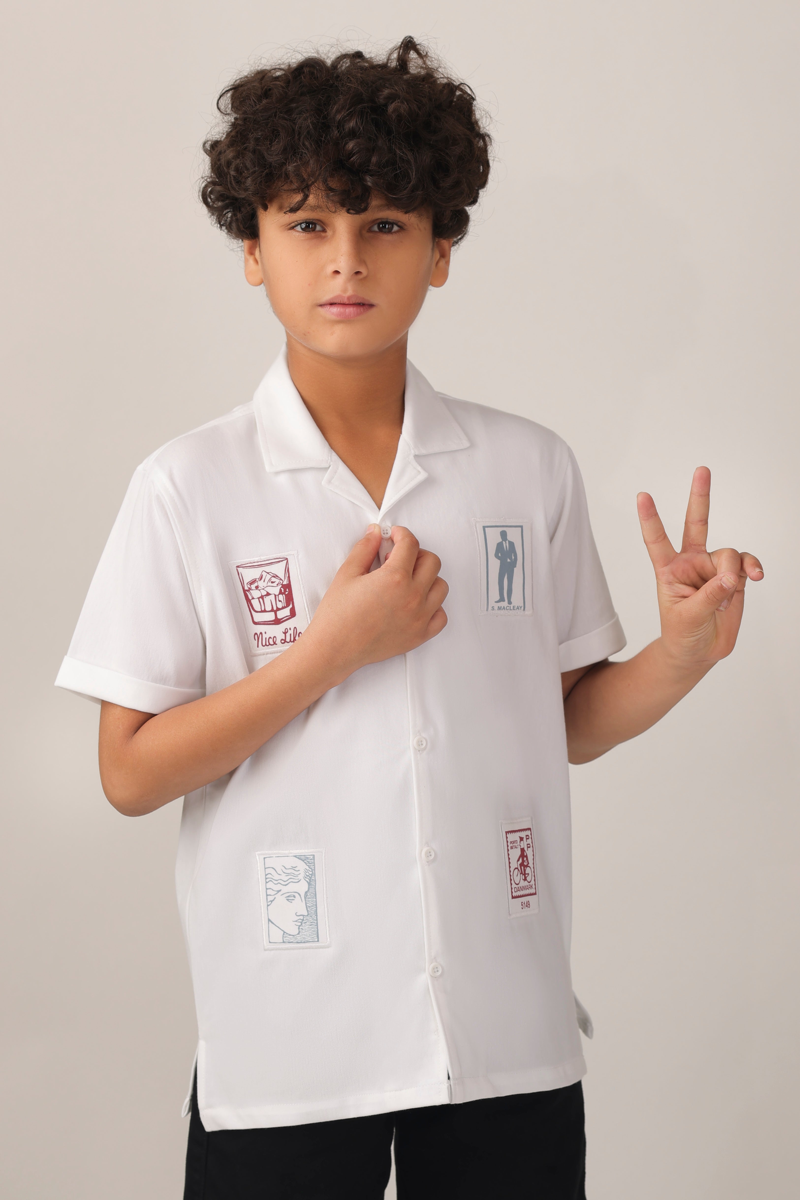 Crisp white short-sleeve design with camp collar