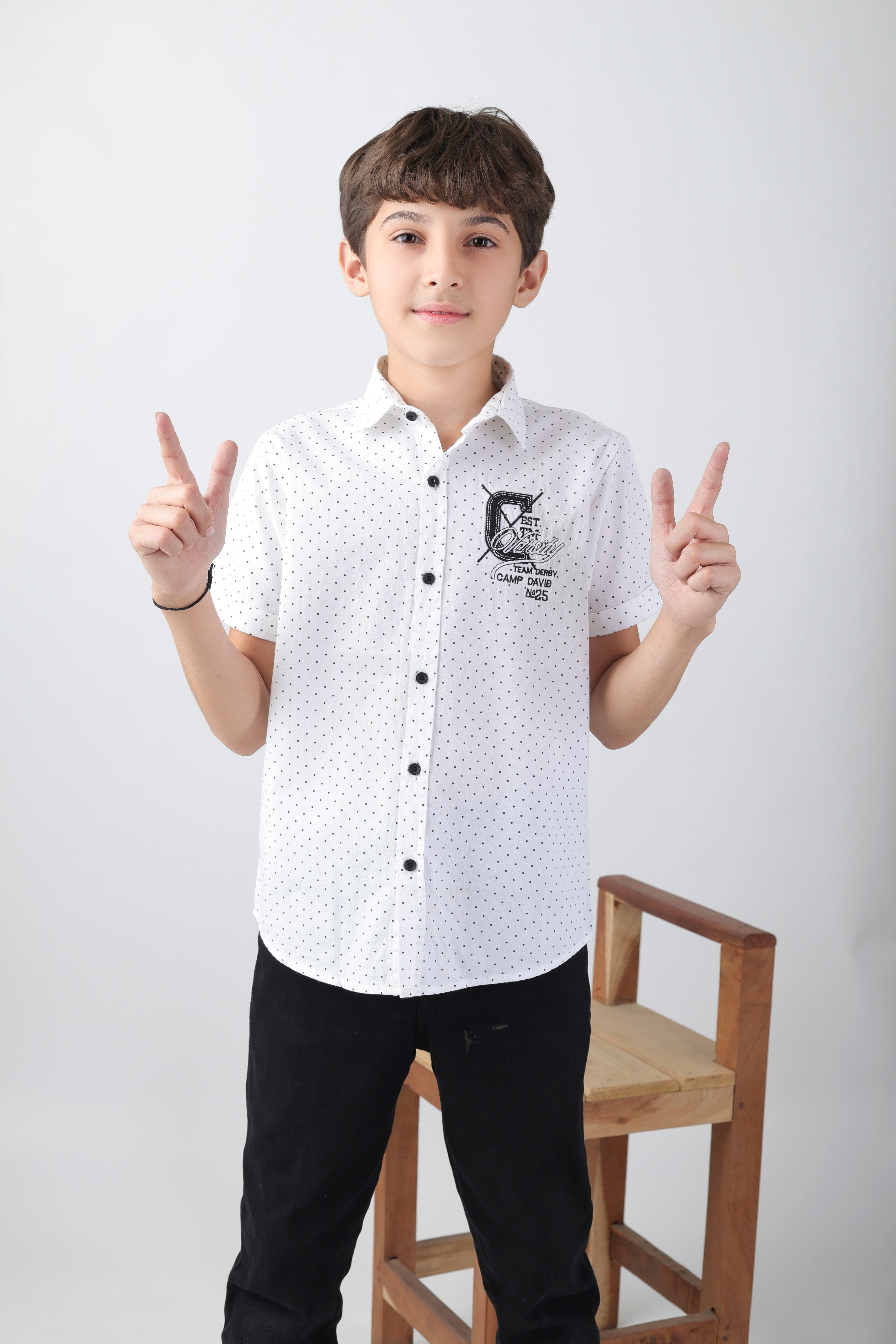 Crisp white short sleeve shirt with a polka-dot base and an embroidery patch
