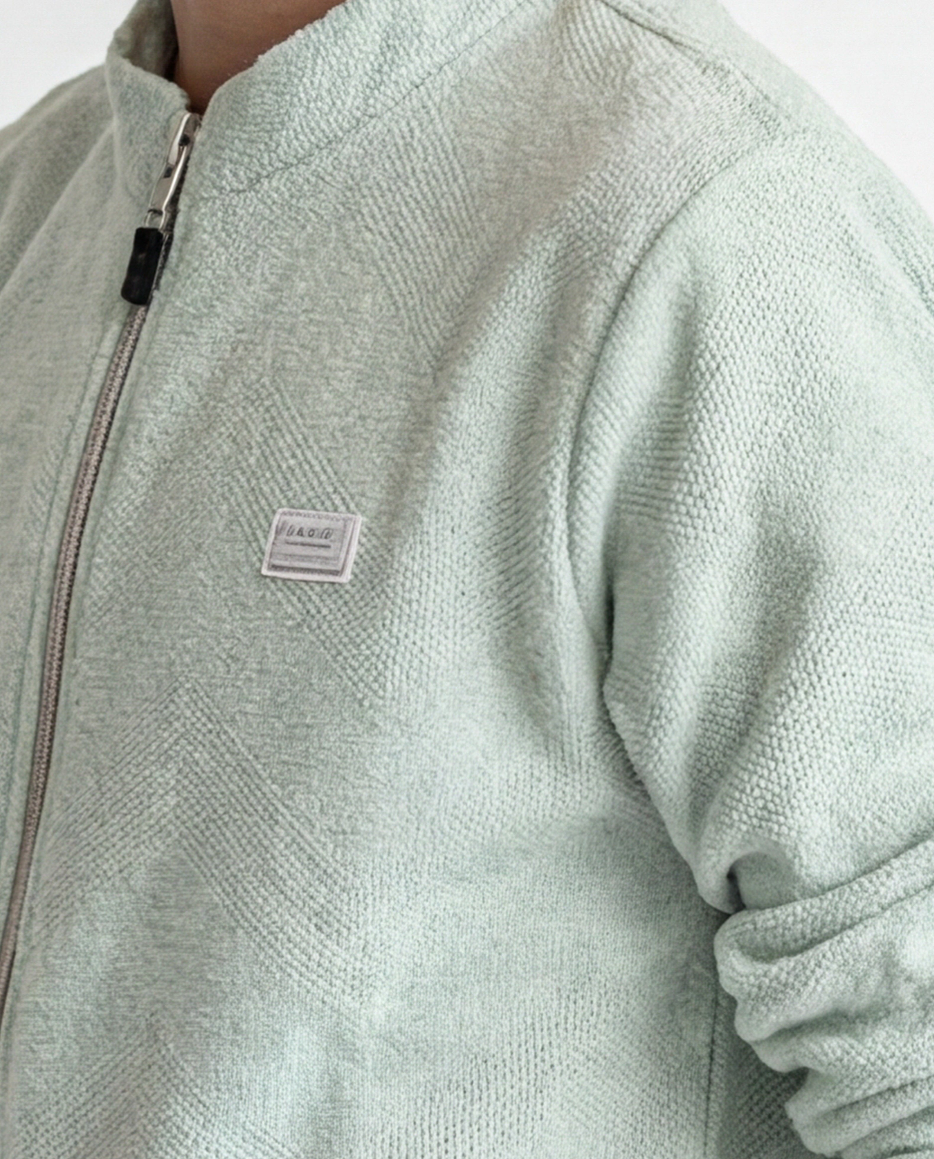 Boys' jacket with a full zip front and stand collar.