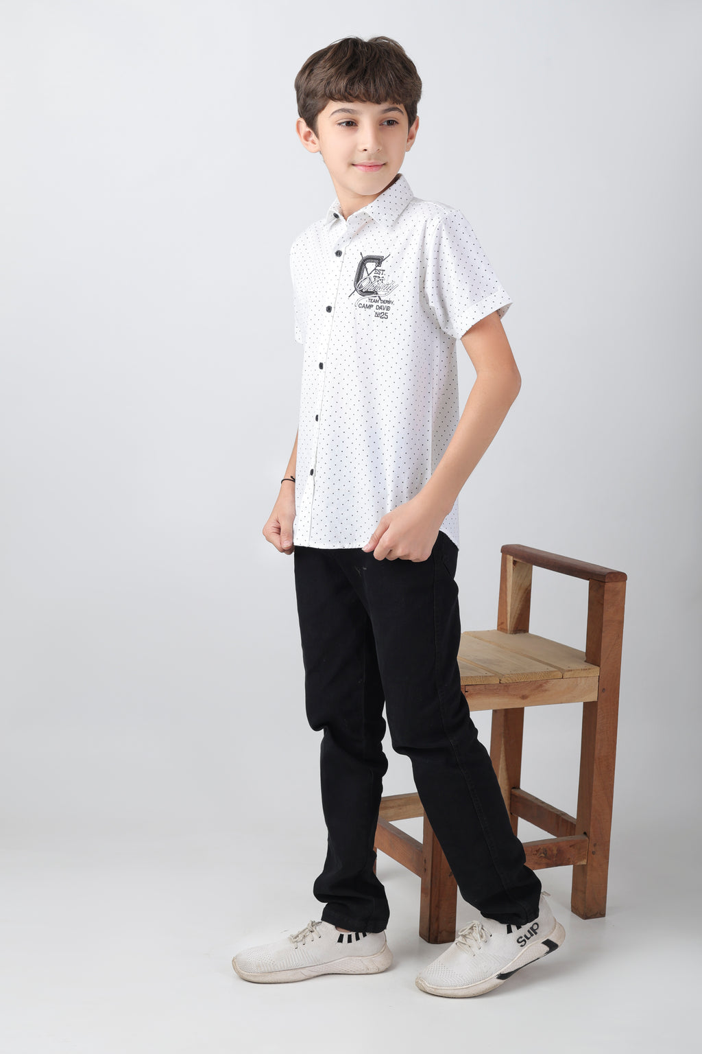 Crisp white short sleeve shirt with a polka-dot base and an embroidery patch